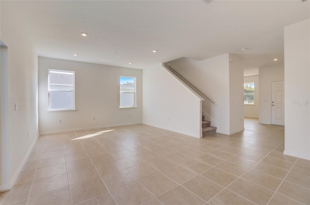 unfurnished room with light tile patterned floors, stairs, baseboards, and recessed lighting