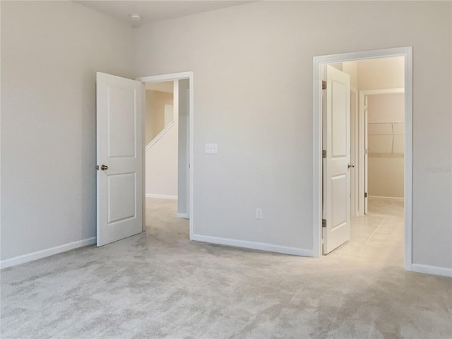 unfurnished bedroom featuring baseboards and carpet flooring