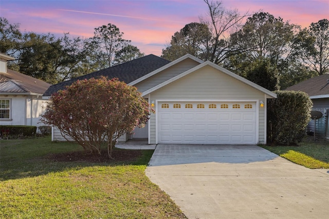 view of front of house featuring a garage, a front lawn, and concrete driveway