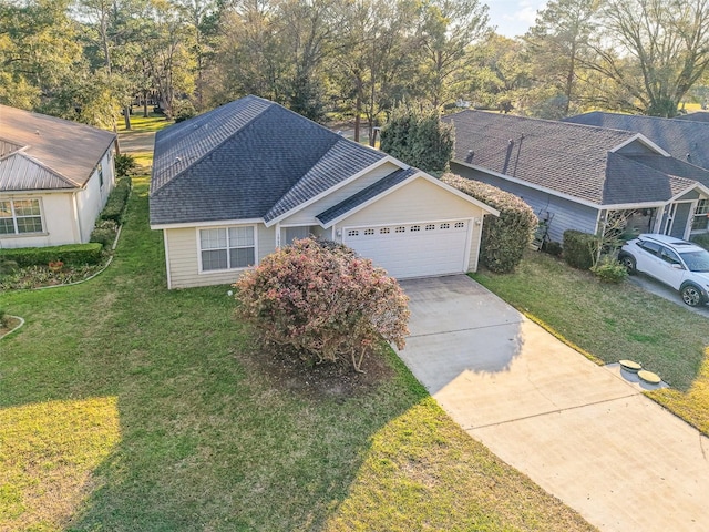 single story home with an attached garage, a shingled roof, a front lawn, and concrete driveway