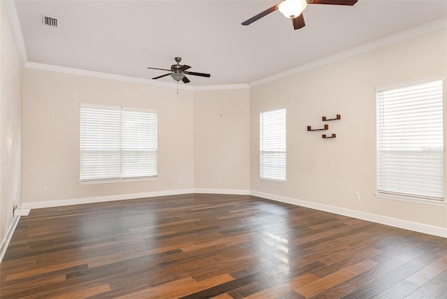 empty room featuring dark wood-style floors, plenty of natural light, and visible vents