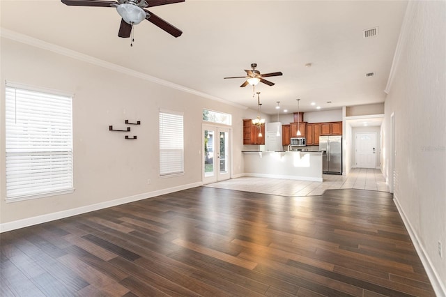 unfurnished living room featuring light wood-style flooring, visible vents, and crown molding