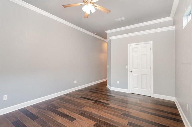 empty room featuring dark wood-style floors, ornamental molding, baseboards, and ceiling fan