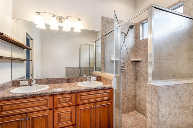 bathroom featuring double vanity, a shower stall, and a sink