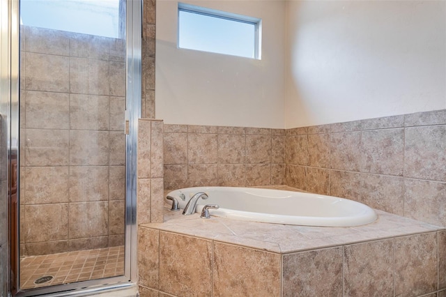 full bath featuring a stall shower and a garden tub