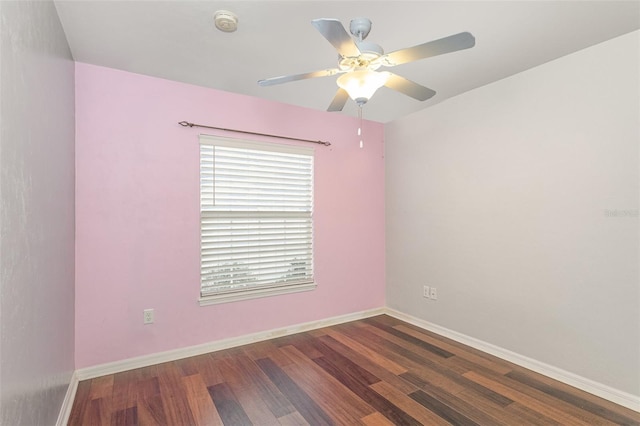 spare room with ceiling fan, wood finished floors, and baseboards