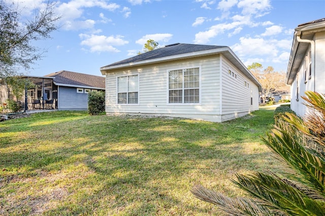 rear view of property featuring a lawn