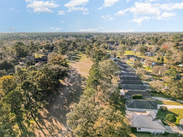 birds eye view of property with a forest view