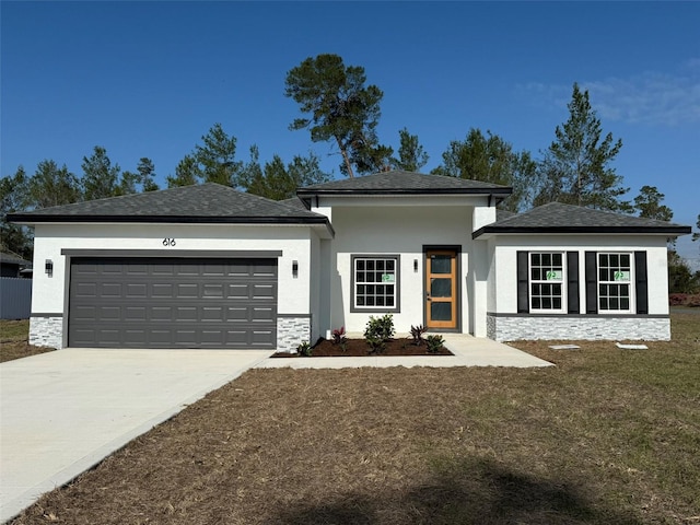 view of front of house featuring stone siding, driveway, and an attached garage