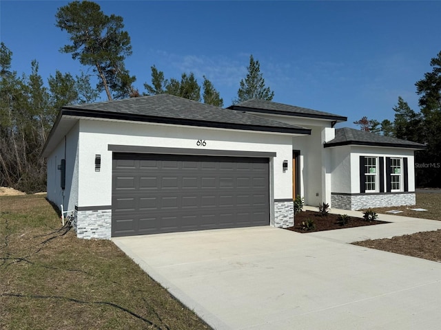 view of front of property featuring a garage, stone siding, concrete driveway, and stucco siding