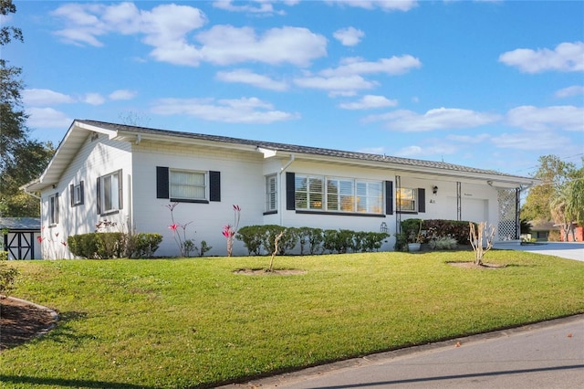 single story home featuring an attached garage, concrete driveway, and a front yard