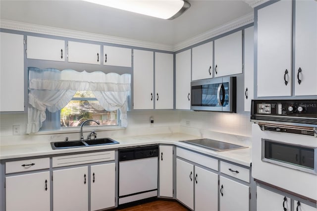 kitchen featuring light countertops, white appliances, and white cabinets