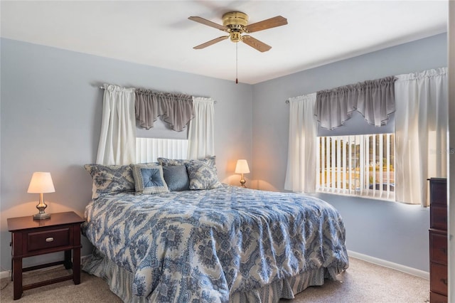 carpeted bedroom featuring ceiling fan and baseboards