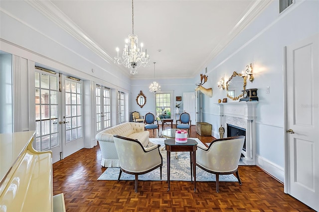 living room featuring french doors, crown molding, a fireplace, a notable chandelier, and visible vents