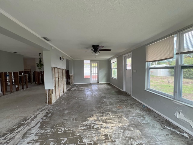 4435 Huntington St NE, Saint Petersburg, FL 33703 - unfurnished living room with ornamental molding, visible vents, a textured ceiling, and baseboards