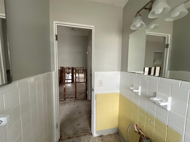 4435 Huntington St NE, Saint Petersburg, FL 33703 - bathroom with concrete floors, wainscoting, and tile walls