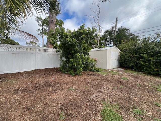 4435 Huntington St NE, Saint Petersburg, FL 33703 - view of yard featuring a storage unit, fence, and an outdoor structure