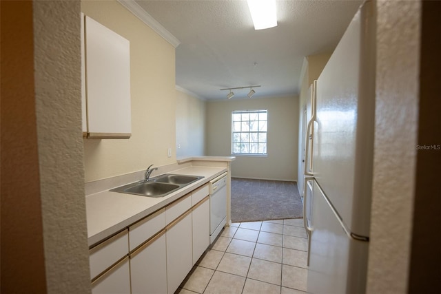 kitchen with crown molding, light countertops, white cabinets, a sink, and white appliances