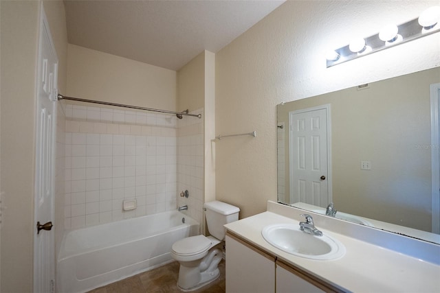 bathroom with toilet, a textured wall, bathtub / shower combination, and vanity