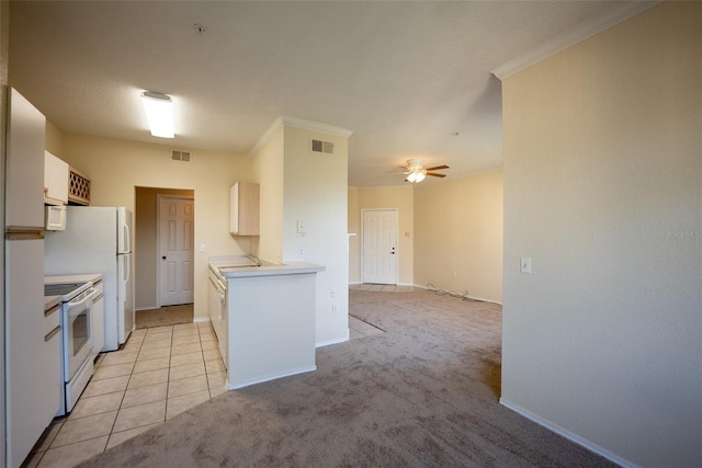 kitchen with crown molding, white appliances, visible vents, and light colored carpet