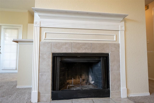 room details with carpet floors, a tile fireplace, and baseboards