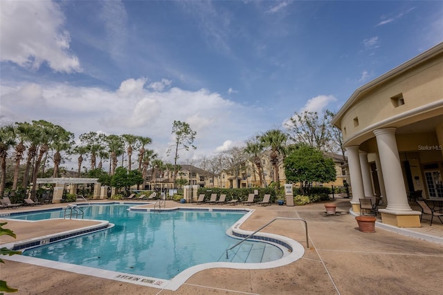 community pool featuring a patio area and fence