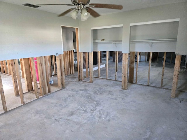 interior space with ceiling fan and visible vents