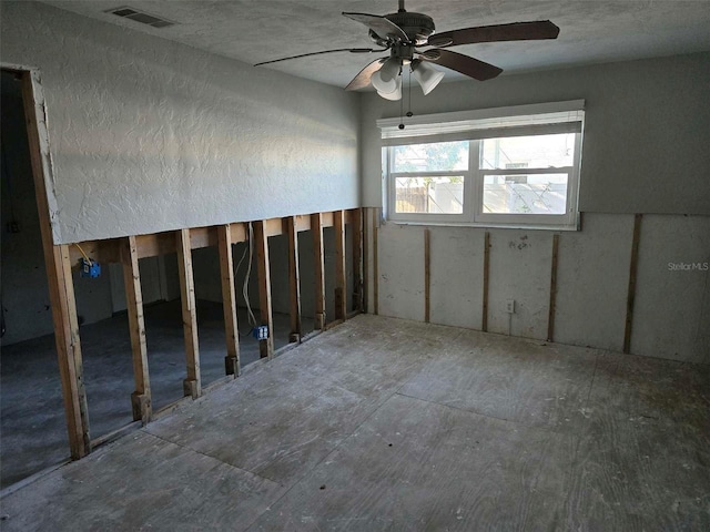 unfurnished room featuring visible vents and a ceiling fan