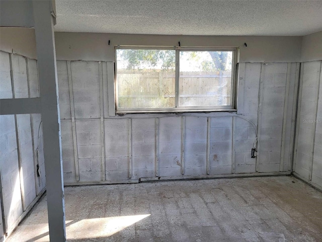 spare room with a textured ceiling