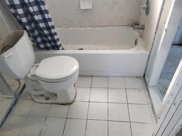 bathroom with shower / tub combo with curtain, toilet, and tile patterned floors