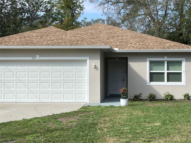 single story home featuring an attached garage, a shingled roof, driveway, stucco siding, and a front yard