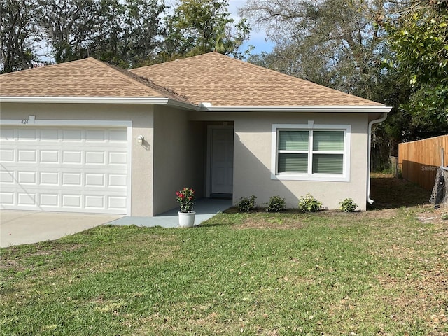 ranch-style house with a garage, a shingled roof, a front yard, and stucco siding