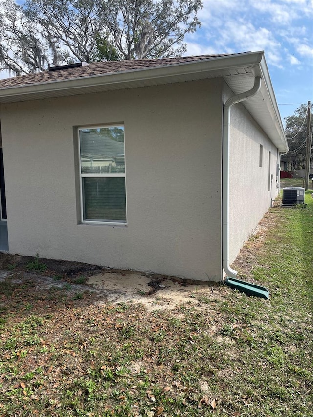 view of property exterior with central AC and stucco siding