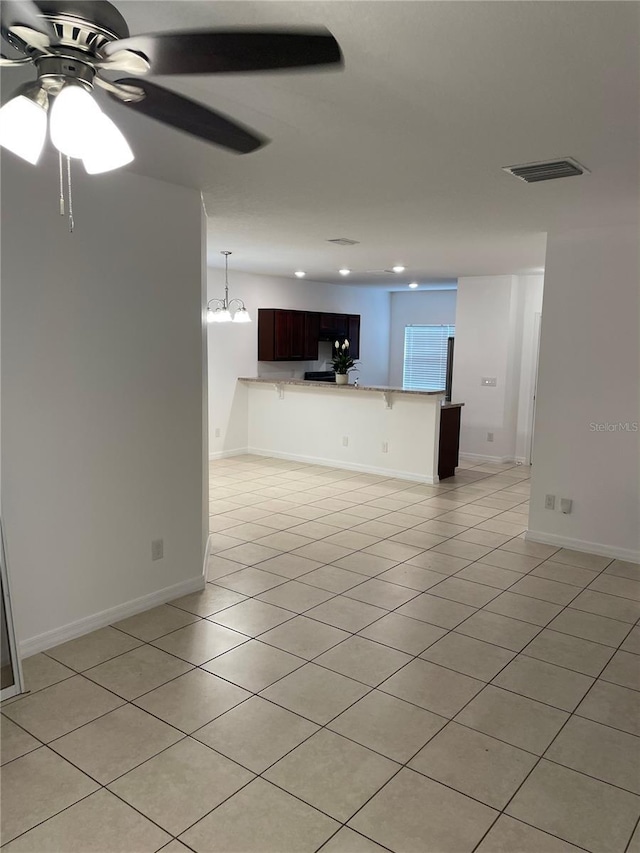 unfurnished living room featuring baseboards, visible vents, a ceiling fan, light tile patterned flooring, and recessed lighting