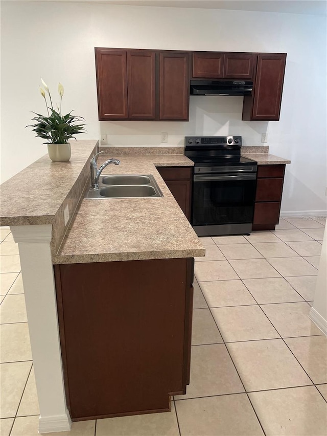 kitchen featuring black electric range, light tile patterned floors, light countertops, a sink, and under cabinet range hood