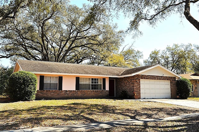 ranch-style house featuring brick siding, driveway, and an attached garage