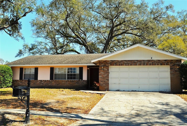 ranch-style home with concrete driveway, brick siding, and an attached garage