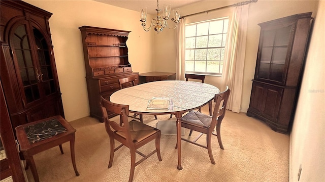 dining space with light carpet and a notable chandelier