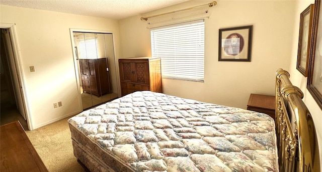 bedroom with light colored carpet, a textured ceiling, and baseboards