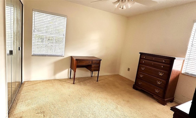 bedroom with baseboards, ceiling fan, and light colored carpet