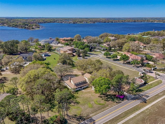 drone / aerial view with a residential view and a water view