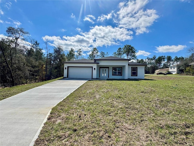 view of front of property featuring a garage, concrete driveway, a front yard, and stucco siding