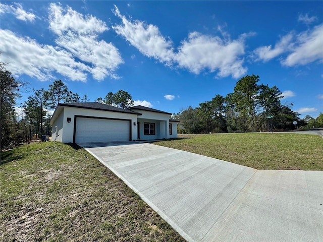 view of front facade with an attached garage, driveway, a front lawn, and stucco siding