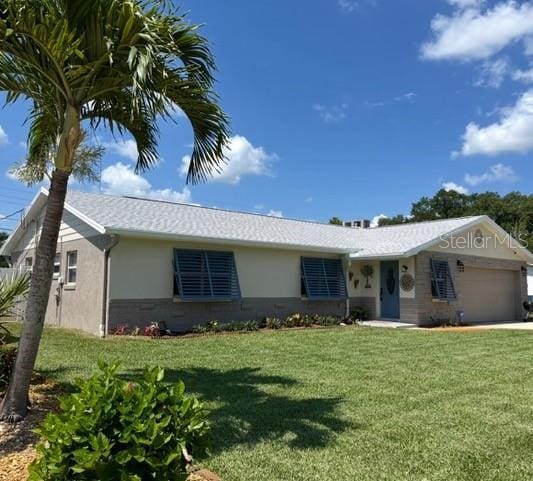 ranch-style home with a front lawn, stucco siding, and an attached garage