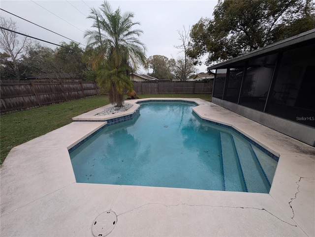 view of swimming pool with a sunroom, a patio area, a fenced backyard, and a fenced in pool