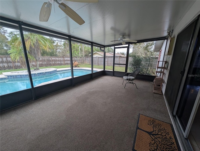 unfurnished sunroom featuring ceiling fan