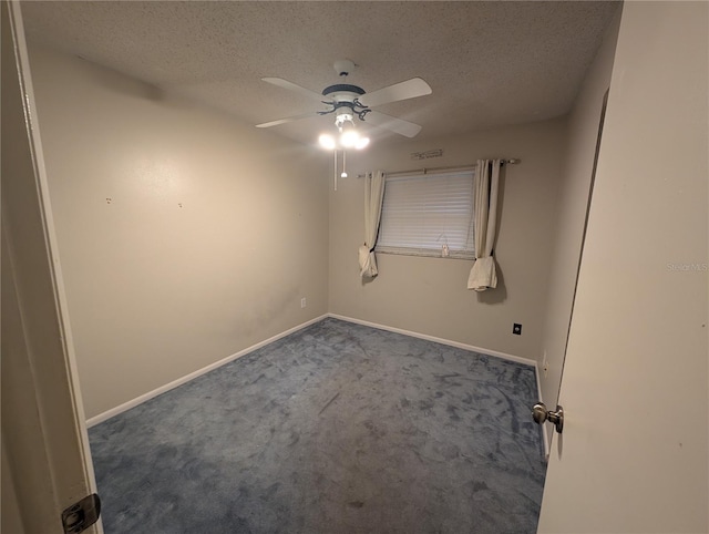 unfurnished room with dark carpet, a textured ceiling, baseboards, and ceiling fan