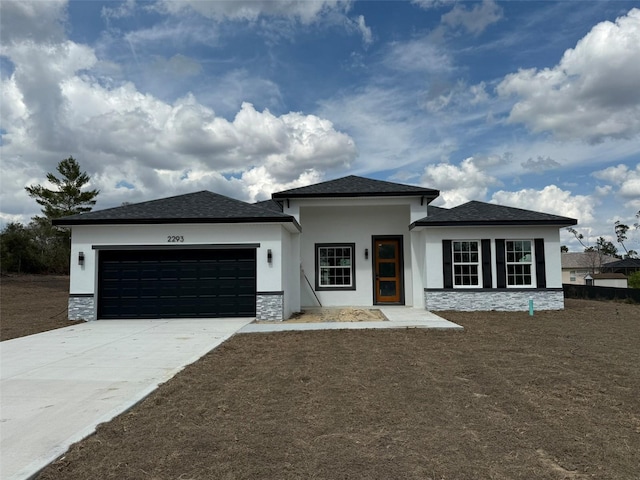 view of front of home with a garage, stone siding, concrete driveway, and stucco siding