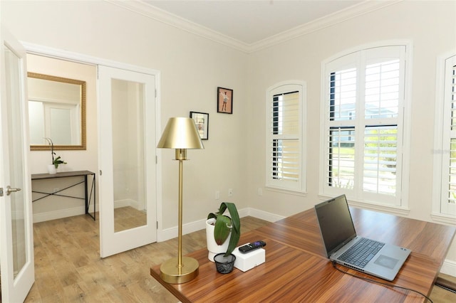 home office featuring french doors, crown molding, light wood-style flooring, and baseboards