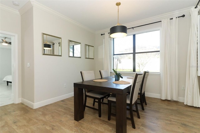 dining room with light wood-style floors, baseboards, ornamental molding, and ceiling fan